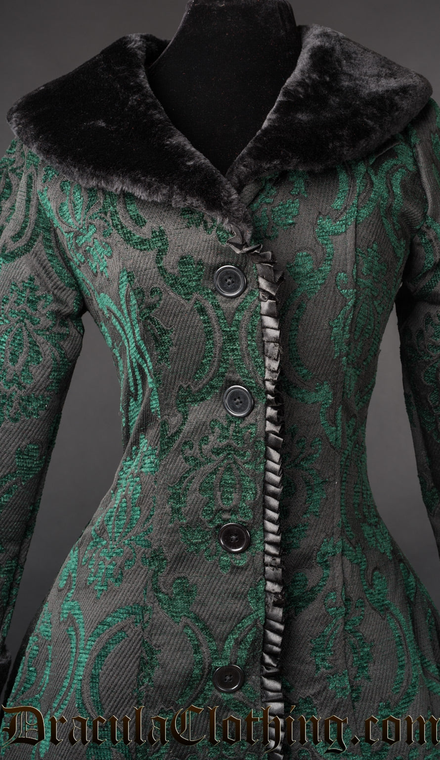 Close up of the front of green brocade women's winter coat showing button closure and ruffled satin trim