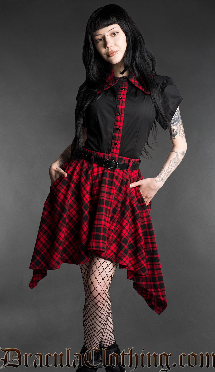 Black and red tartan high-low skirt with asymmetrical hem worn with fitted black top