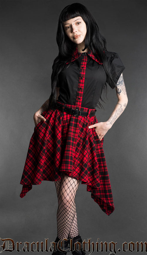 Black and red tartan high-low skirt with asymmetrical hem worn with fitted black top