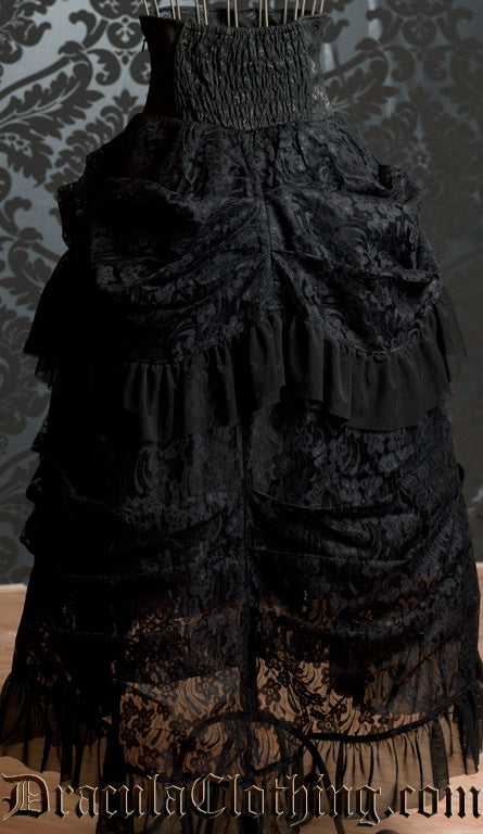 Back view of black high waisted women's bustle skirt showing many lace layers and elasticated back part of waistband
