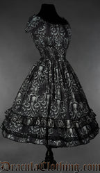 Side view of grey kraken inspired print on black women's dress showing elasticated waist and sleeves