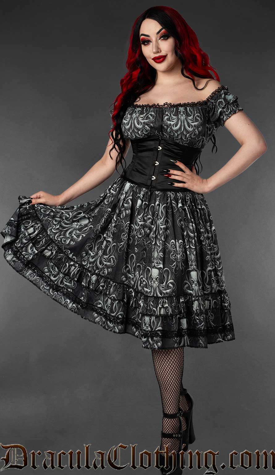 Model wearing knee length grey and black dress with kraken inspired print and black lace in the elasticated bust