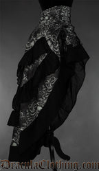 Side view of grey and black women's bustle skirt with kraken inspired print and black accents on the hem of each layer