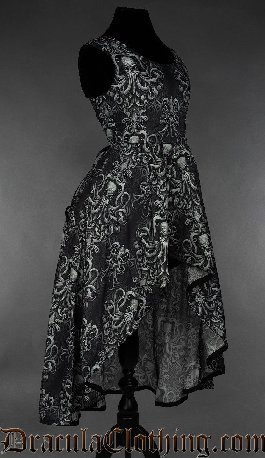 Side view of grey kraken print women's sleeveless dress showing longer skirt in the back and short in the front
