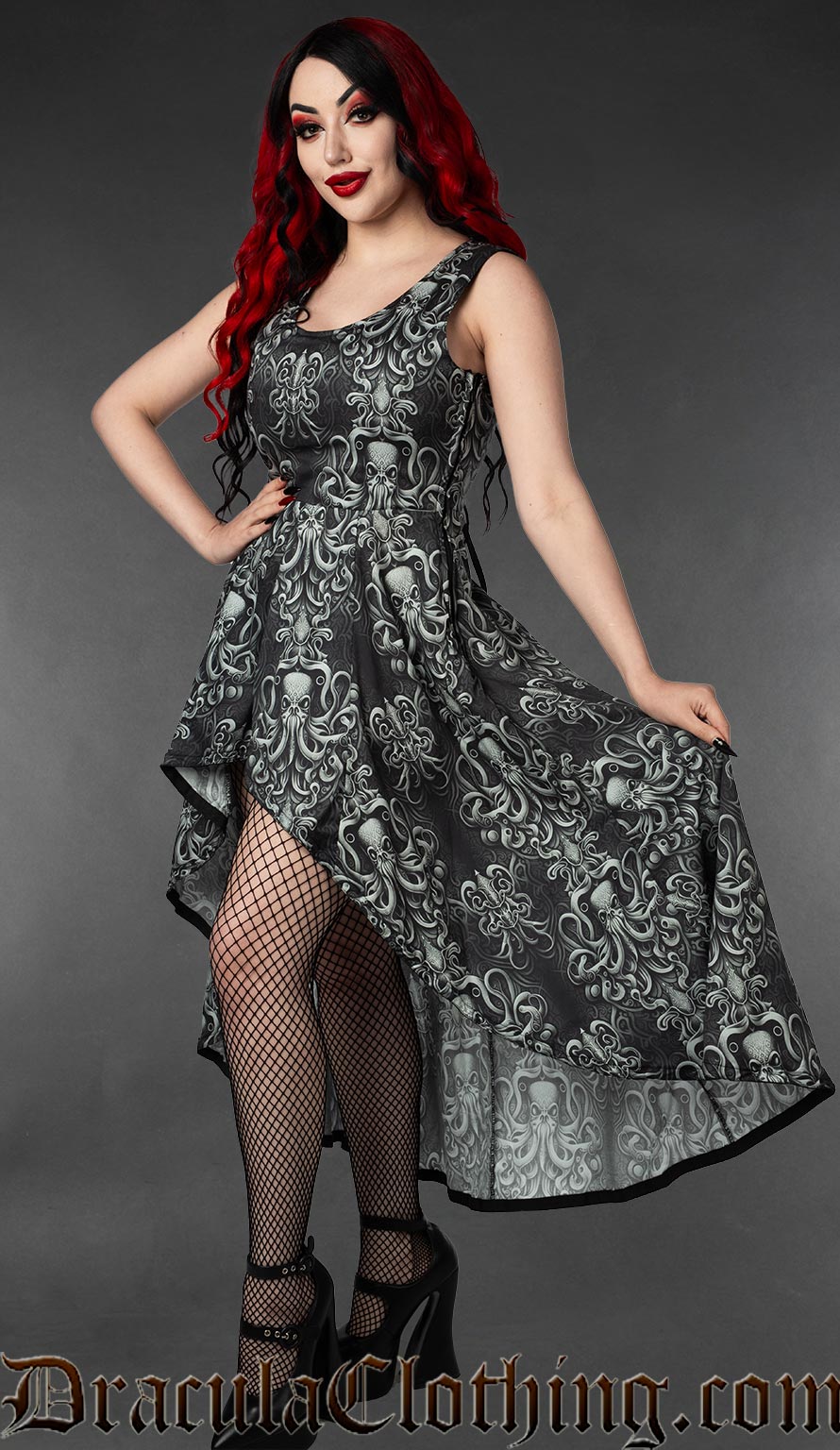 Model wearing high low sleeveless grey and black print dress with kraken inspired design