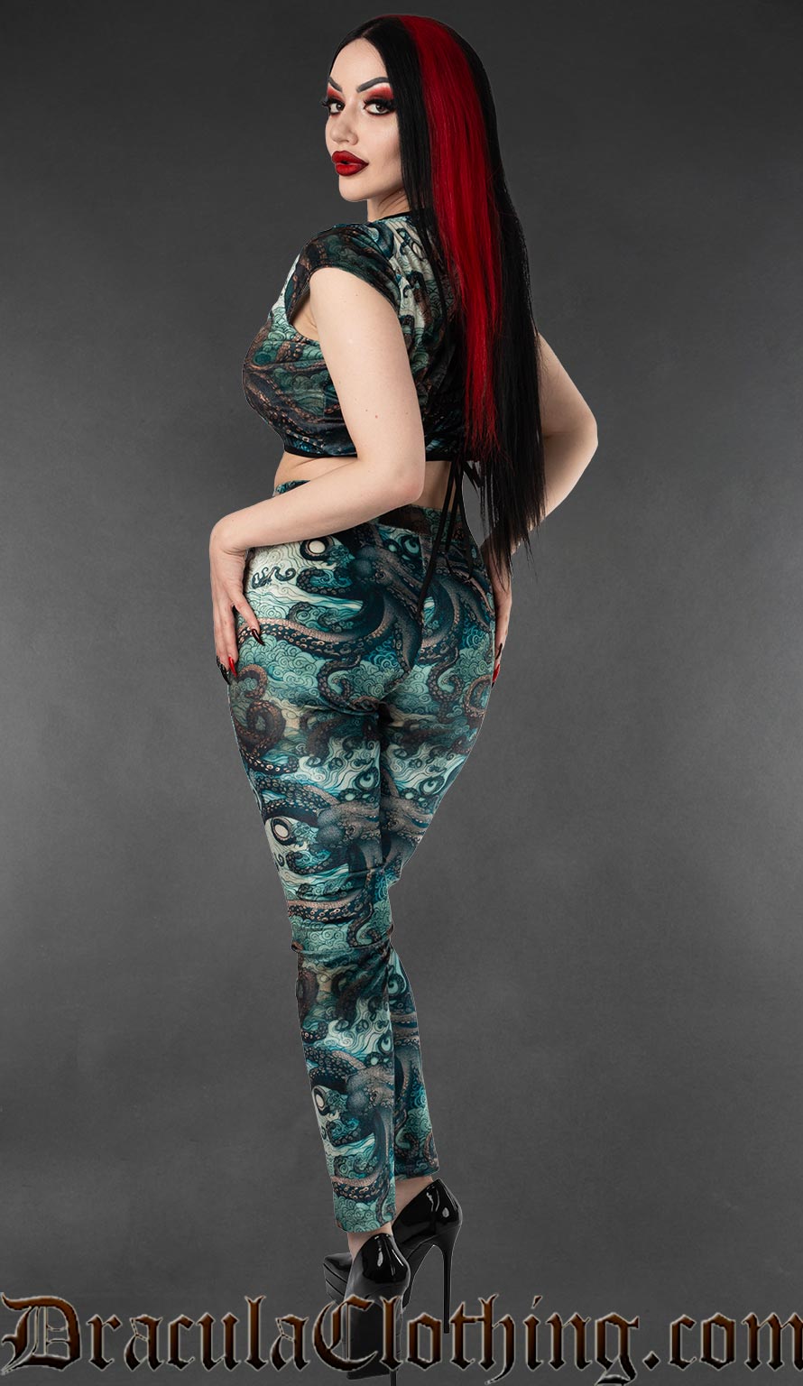 Model wearing gothic velvet leggings with blue kraken and tentacle print back view