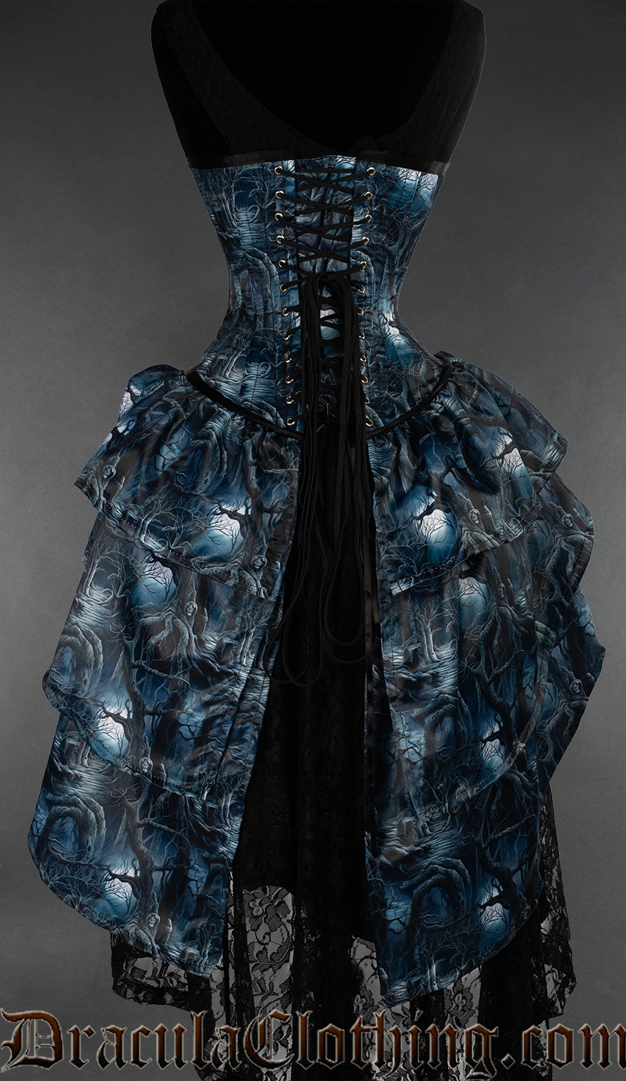Back view of forest inspired bustle corset showing adjustable lacing in the back over matching printed modesty panel and layered skirt