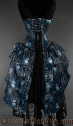 Back view of forest inspired bustle corset showing adjustable lacing in the back over matching printed modesty panel and layered skirt