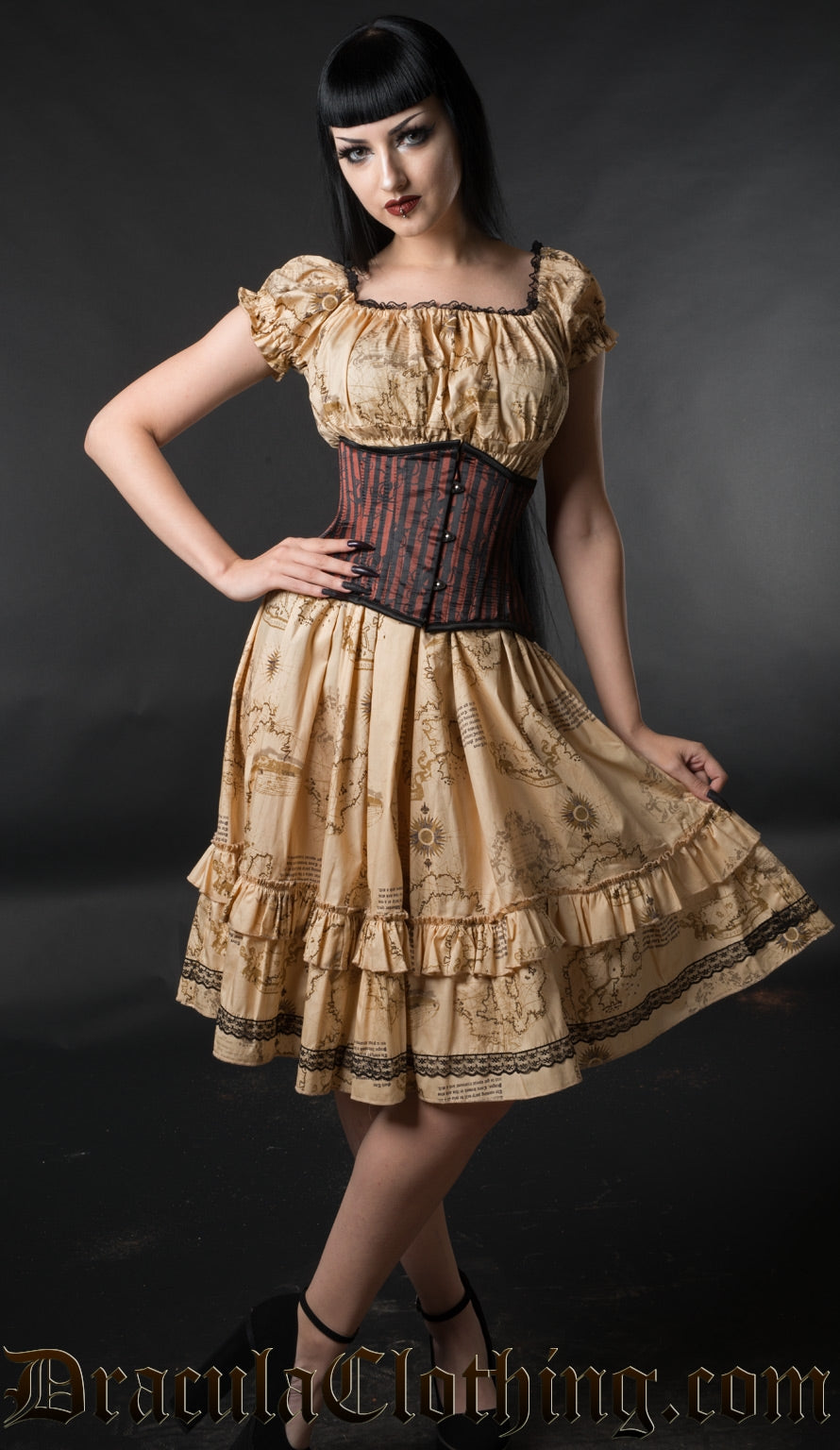 Knee length women's dress with ancient map inspired beige print worn by model with additional waist cincher