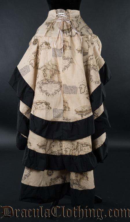 Back view of women's printed beige skirt with map design showing adjustable corset style lacing in the waist and black cotton hem on three tiered layers