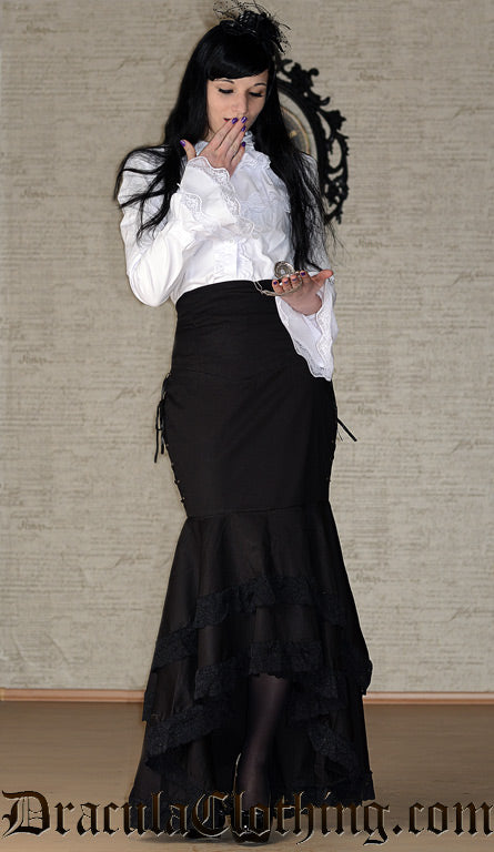 Women's white blouse with long sleeves that are flared at the cuffs and detachable cravat worn by model 