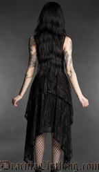 Woman wearing a black gothic mourning dress with lace material, fitted bodice and flowing layered handkerchief hem back view