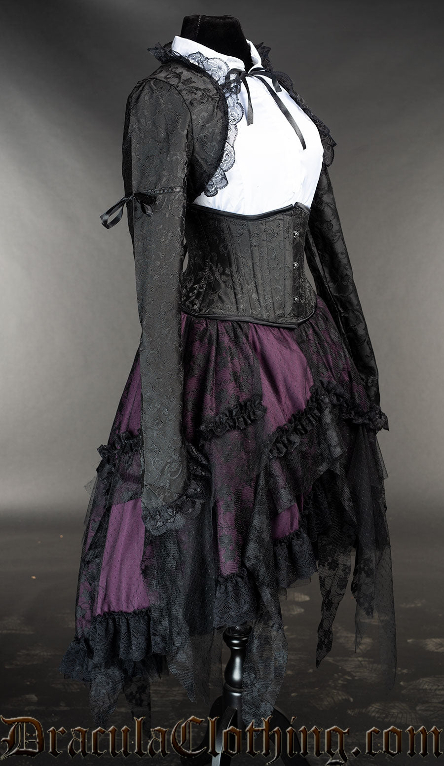 Side view of women's purple ruffle skirt shown with bolero and cincher outfit