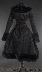Back view of black brocade women's coat showing longer back and adjustable corset style lacing in the torso