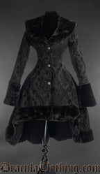 Women's thick winter coat made from black cotton brocade fabric in a damask pattern with short high low hem and faux fur accents on collar cuffs and hem