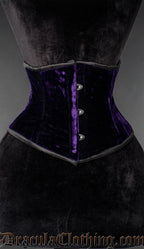 Purple velvet waist cincher corset with front busk closure on a mannequin