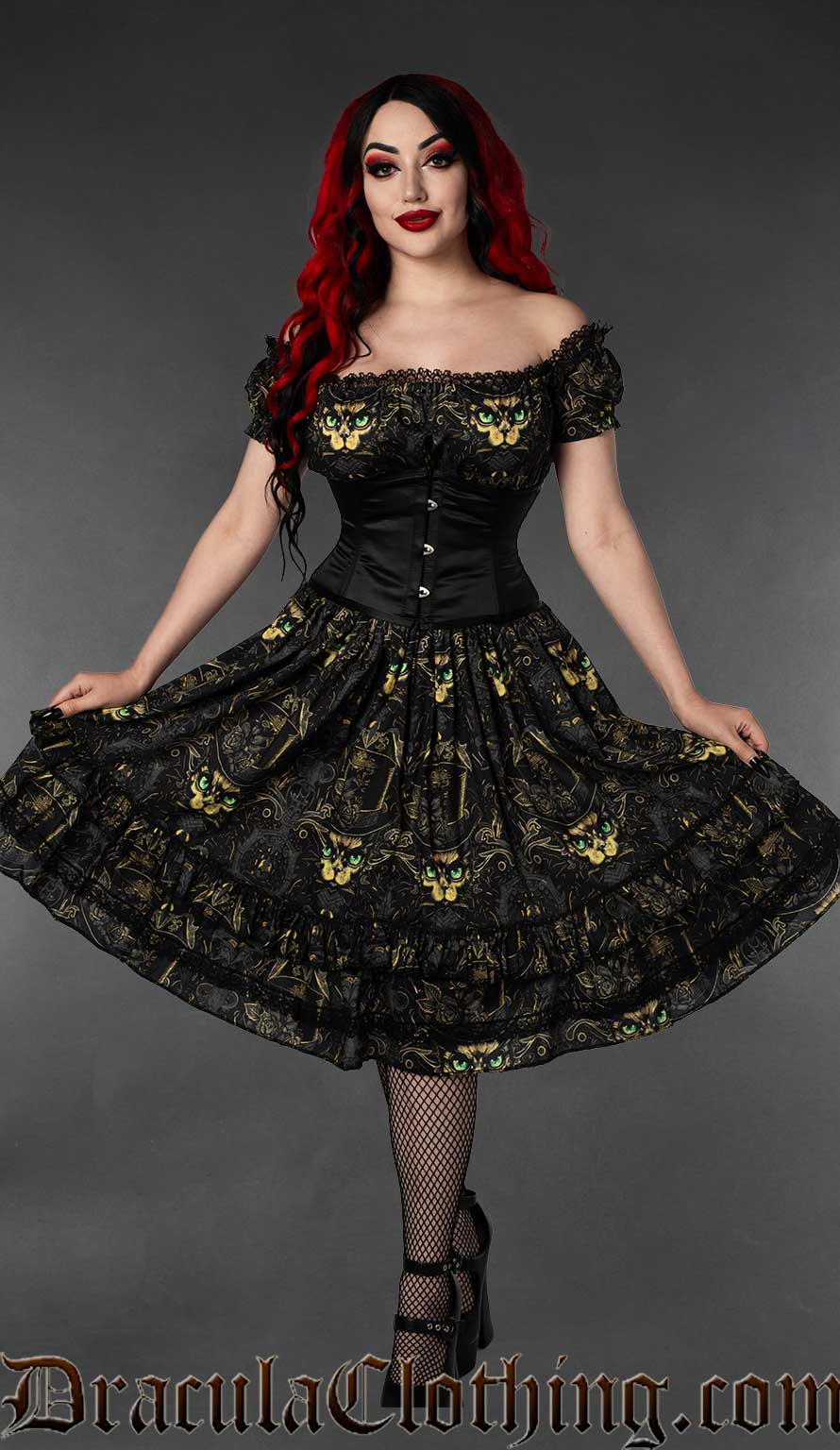 Women's knee length multicoloured dark dress featuring printed sphinx cat in top hat worn by model with waist cincher