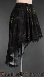Side view of high low women's skirt made in black cotton with a sphinx cat design and black lace trim