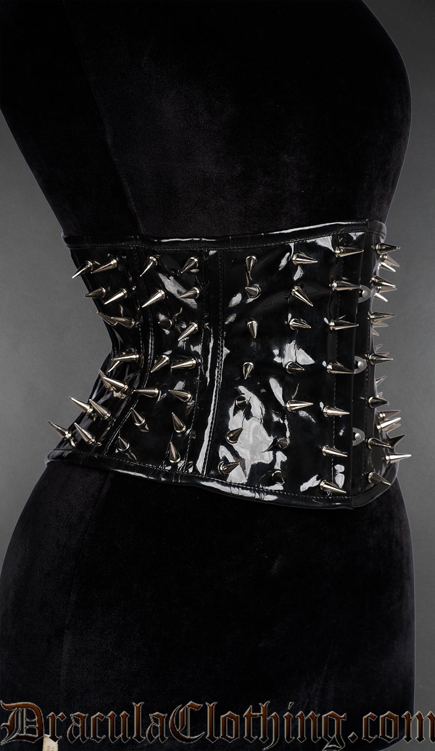 Side view of Black PVC spiked waist cincher with silver metal studs in gothic punk style, with steel boning