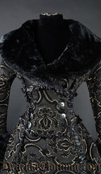 Close up of front of women's gold jacquard winter coat showing black faux fur collar wrap closure with decorative satin frills and buttons