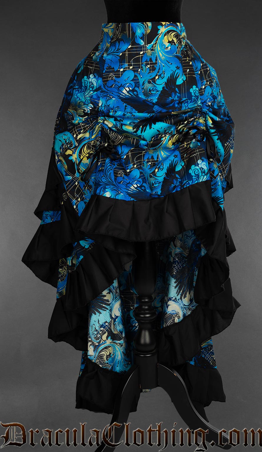 Raven and music themed blue women's layer bustle skirt with black cotton accents pictured with the front raised by two ribbons