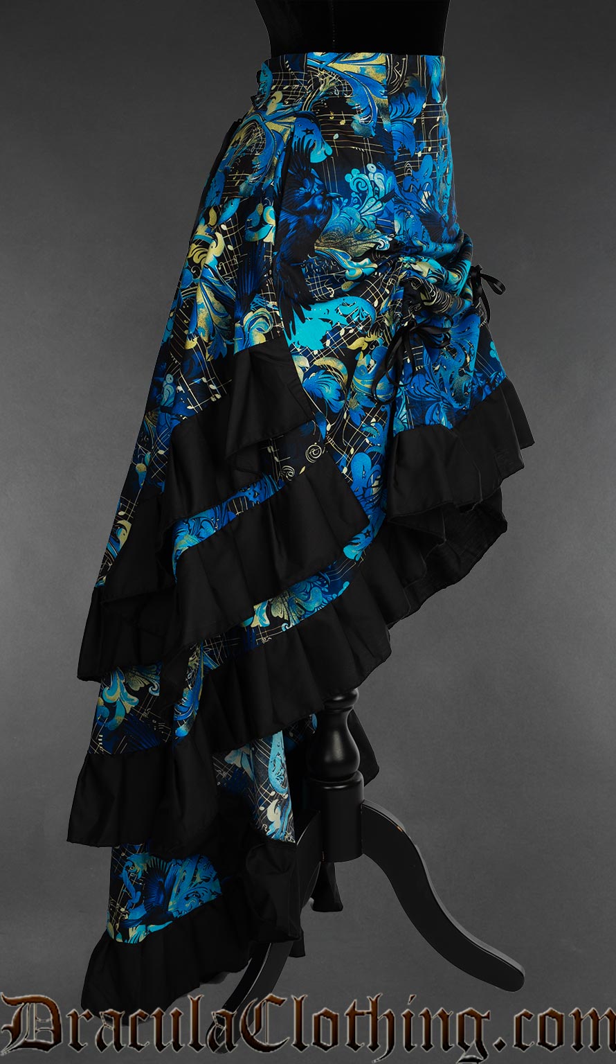 Side view of raven and music themed printed women's bustle skirt showing the three skirt layers and black cotton hem trim