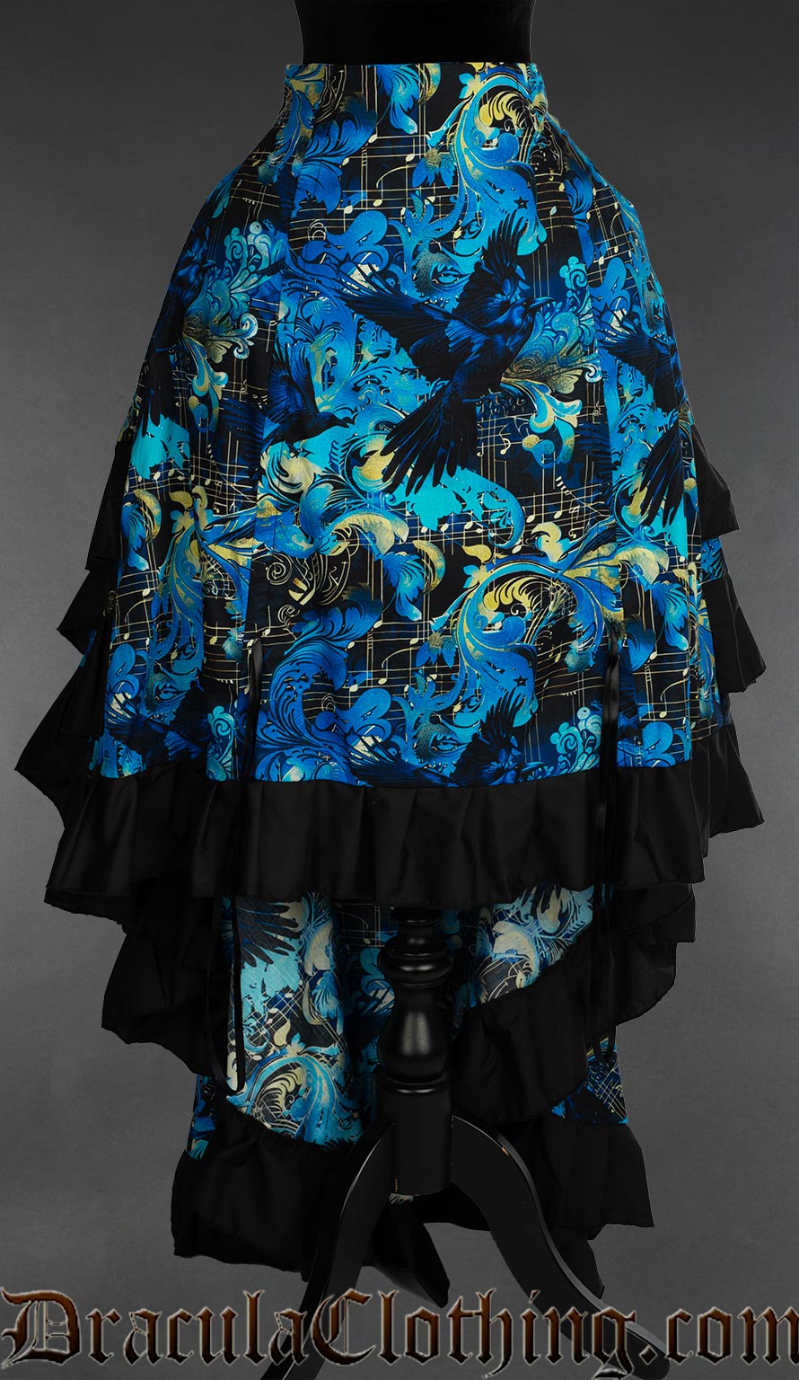 Women's layer bustle skirt in a blue and black raven and music themed print showed with the front lowered