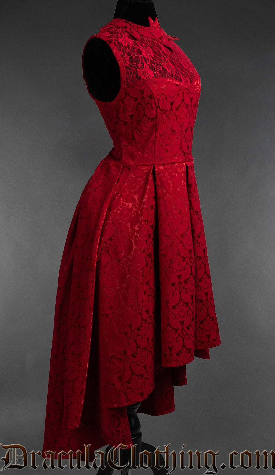Side view of women's red brocade dress with bat collar showing longer skirt in the back and shorter in front