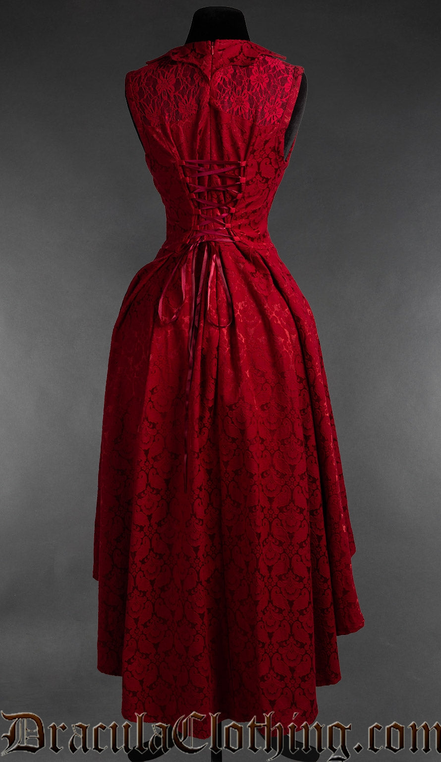 Back view of women's red brocade bat collar dress showing adjustable corset lacing in the torso and longer skirt in the back