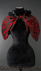 Cape and hood made with red and black brocade shown tied at the front