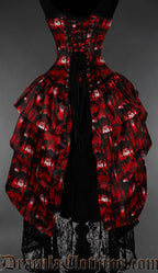 Back view of red gothic cathedral bustle corset showing layered bustle skirt at the back and adjustable lacing with modesty panel