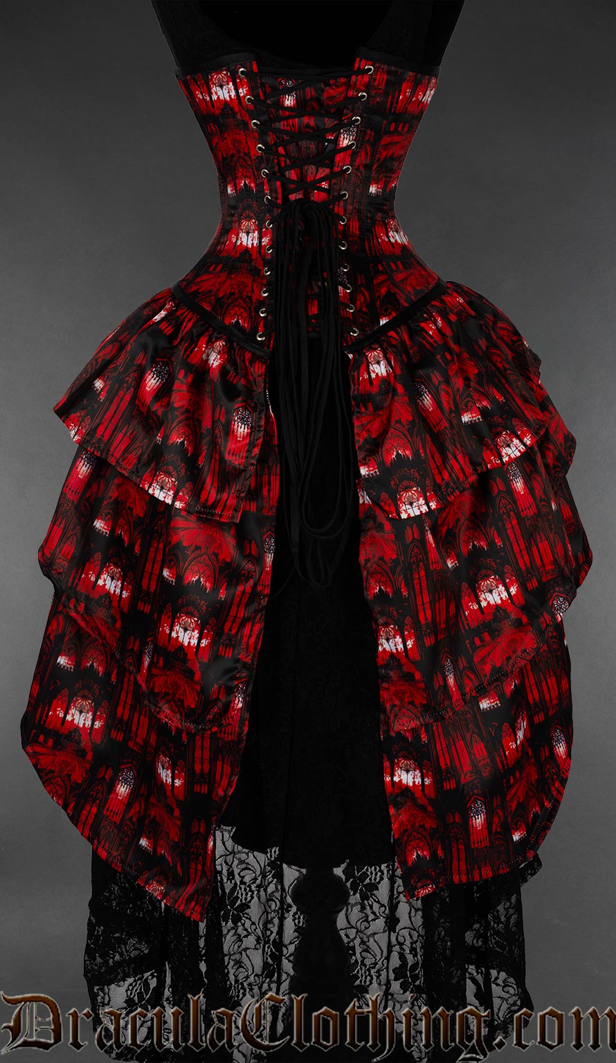 Back view of red gothic cathedral bustle corset showing layered bustle skirt at the back and adjustable lacing with modesty panel