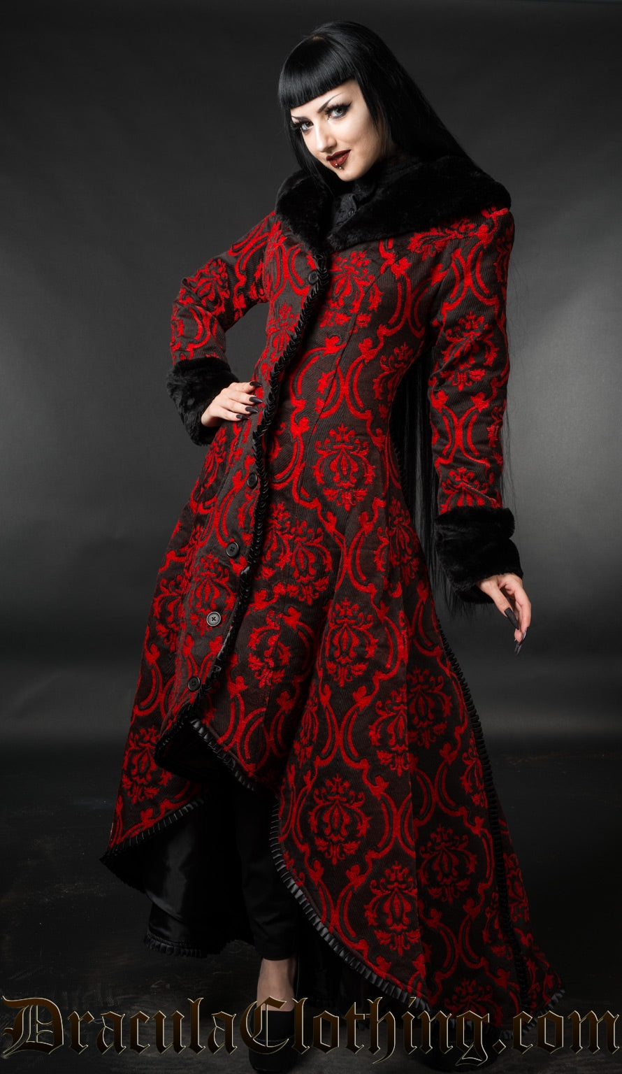Model wearing black and red brocade women's winter coat with high low style button up front and black faux fur accents