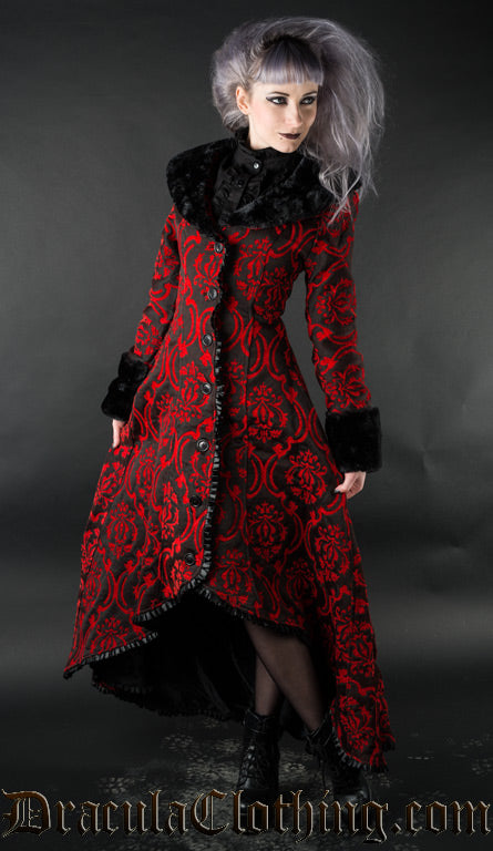 Model in women's black and red button up high low winter coat with faux fur accents and satin trim details