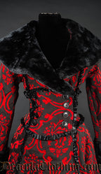 Close up front view of women's red and black brocade coat showing black faux fur collar on a wrap style closure with satin frills and button embellishments