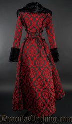 Back view of women's red and black brocade high low coat with black faux fur accents showing adjustable corset style lacing in the back torso