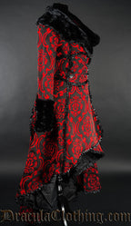 Side view of women's red and black brocade coat showing high low skirt style