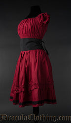 Side view of red women's dress showing elastic bust sleeves and removable black belt