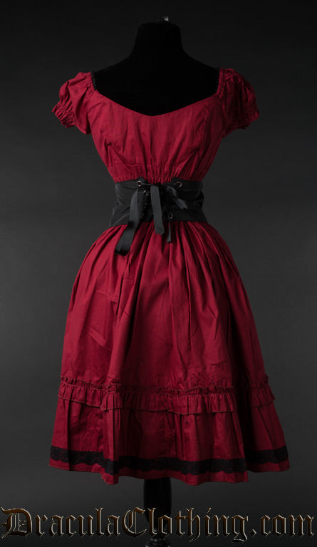 Back view of women's red cotton dress with removable black belt that is tied in the back with ribbon lacing