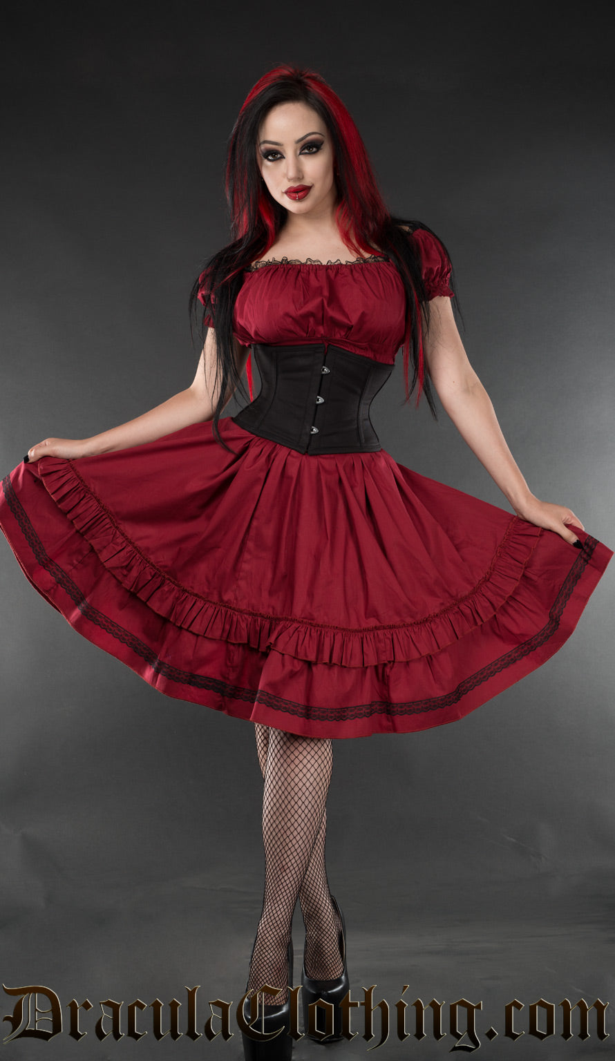 Women's red cotton knee length dress worn by model with additional black waist cincher
