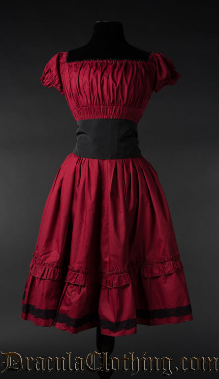 Red cotton women's knee length dress with elasticated bust and sleeves shown with black belt 
