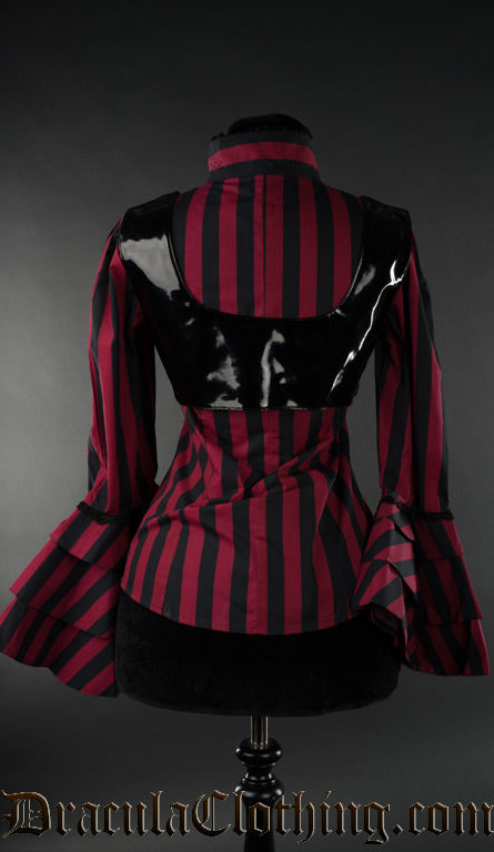 Back view of red striped blouse with black pvc removable harness