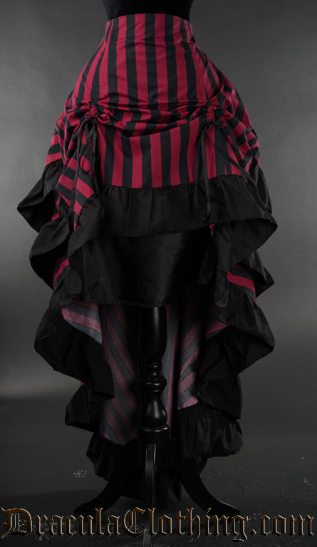 Red and black women's striped layer bustle skirt with black cotton accents on the hem of each layer displayed raised in the front with two ribbons