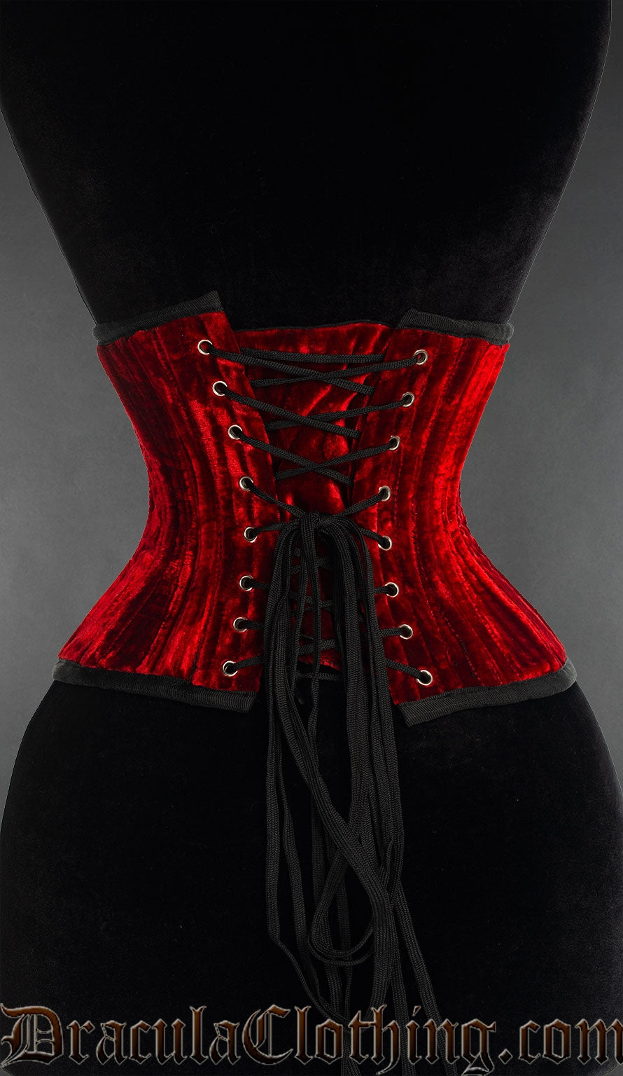 Back view of double boned red velvet waist cincher showing matching modesty panel and adjustable lacing