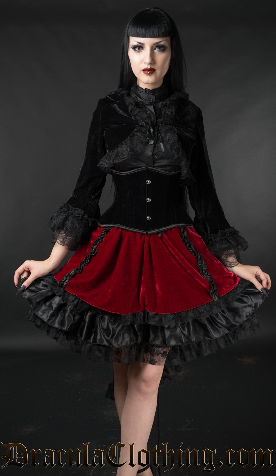 Model wearing black and red velvet skirt with black velvet oufit