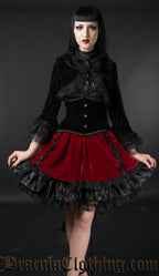 Model wearing black and red velvet skirt with black velvet oufit