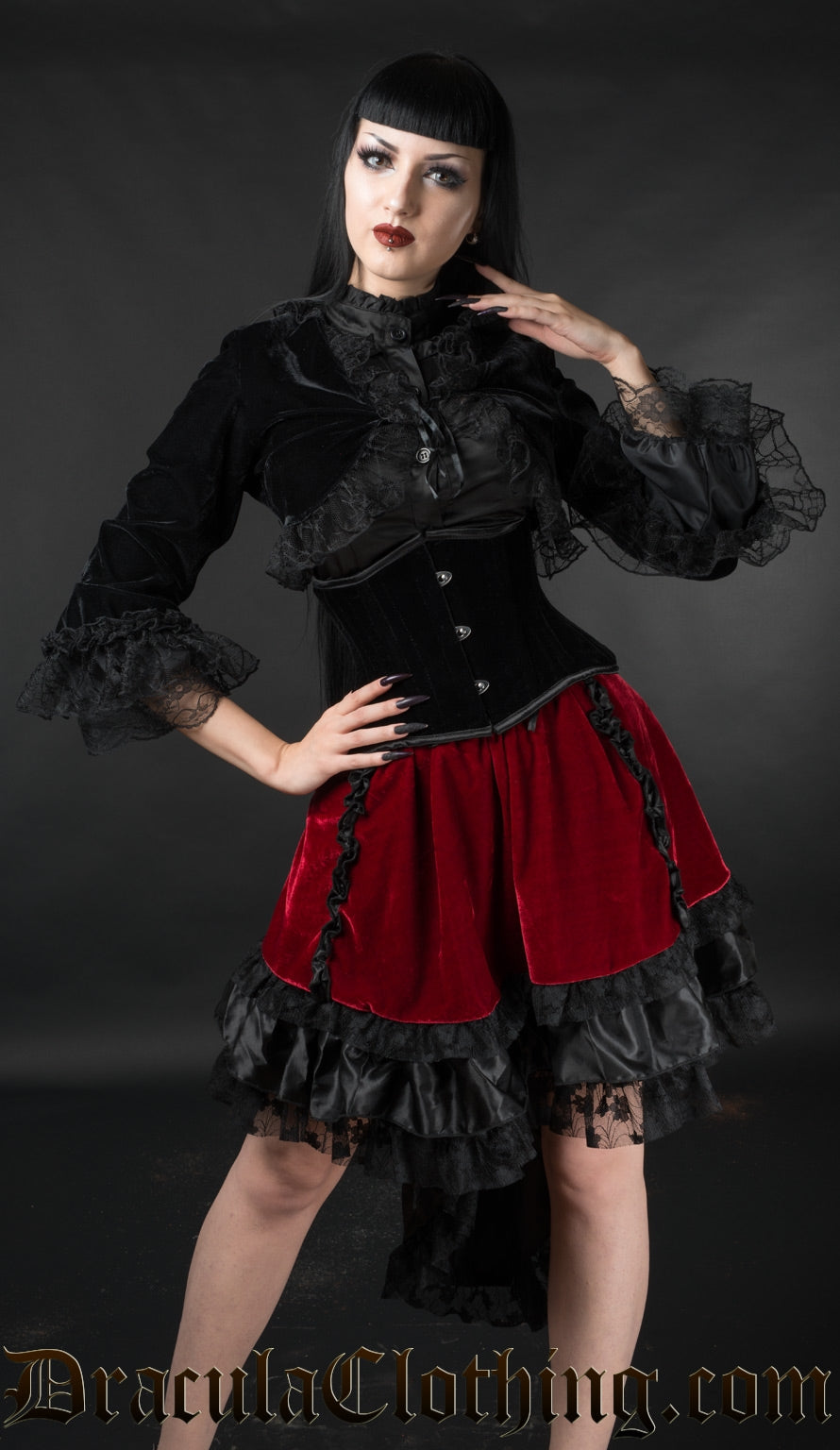 Red velvet EGL skirt worn by model with velvet bolero and cincher