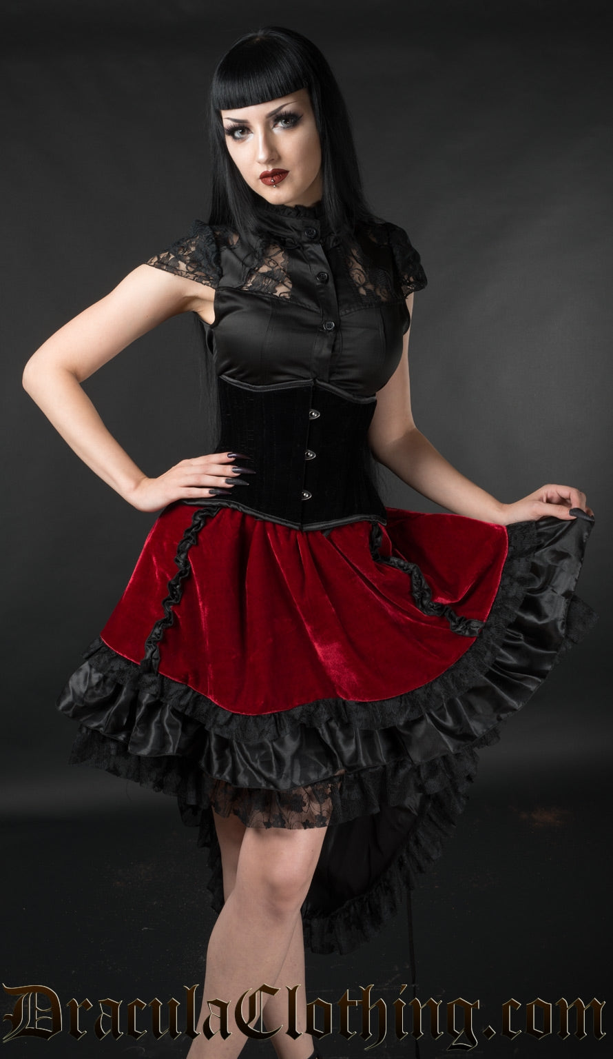 Model wearing red velvet women's high low skirt with black satin and lace accents