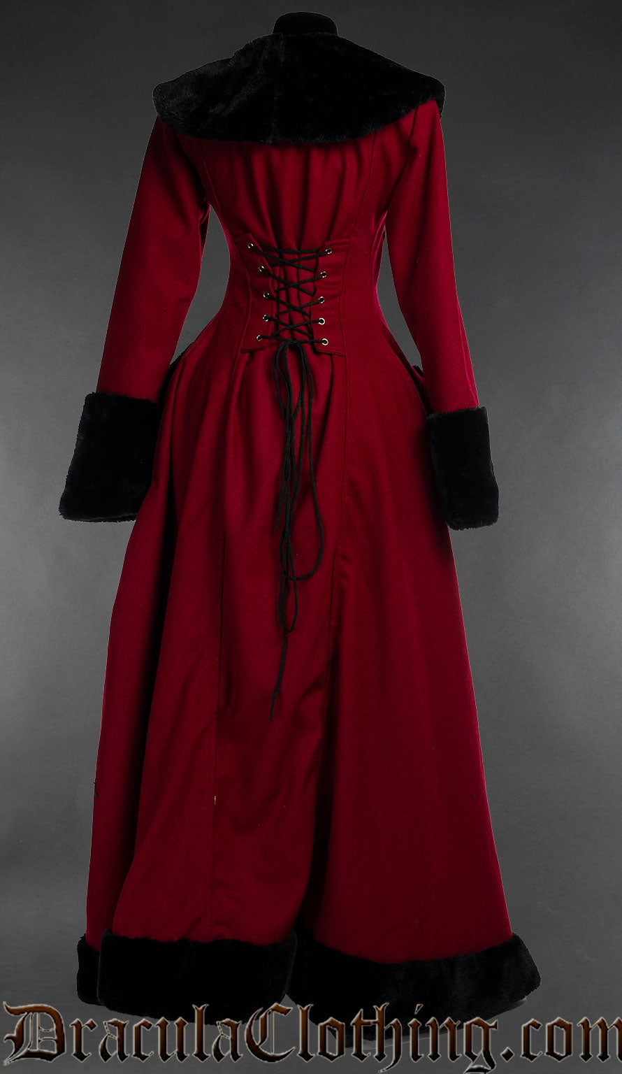 Back view of red wool women's coat with black faux fur accents showing adjustable corset style lacing in the back