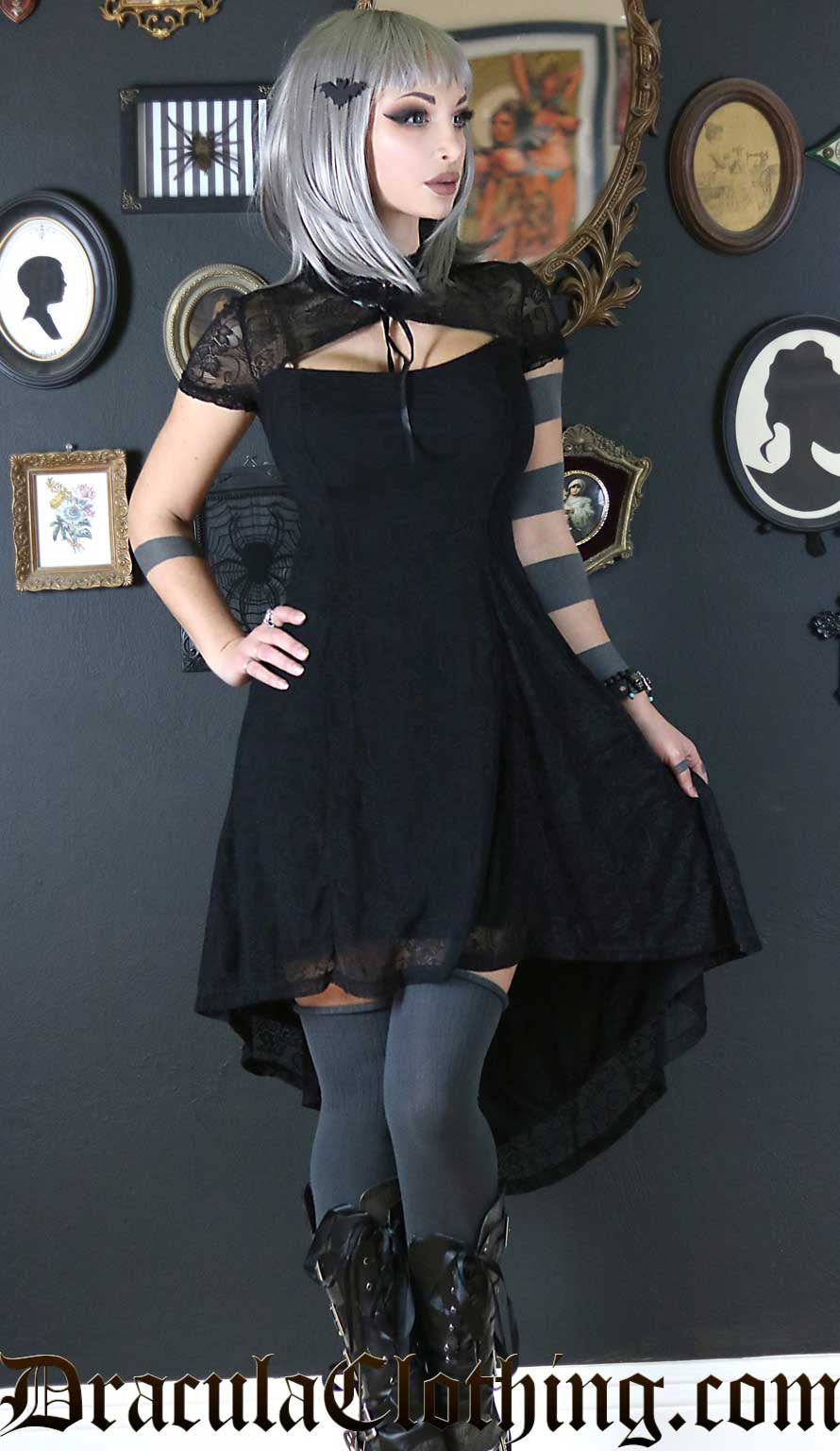 Model wearing lace black high low dress with keyhole neckline